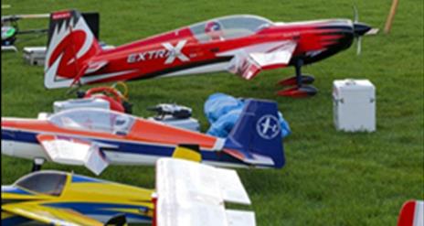Model aeroplanes sitting on the grass ready to fly.
