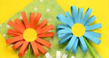 Three daisy flowers made out of paper
