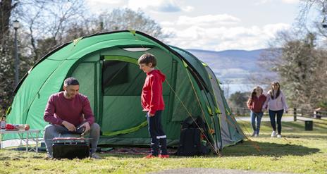 Family enjoying a BBQ infront of their tent in Kilbroney Park