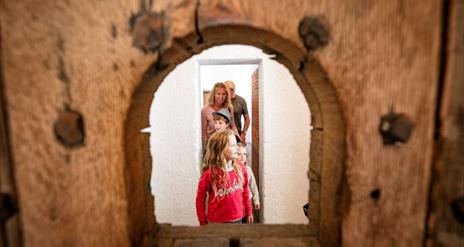 Family exploring restored Gaol cells at Down County Museum