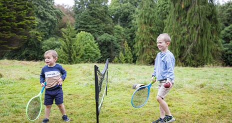 Two boys playing tennis at Rowallane Garden