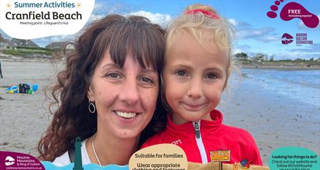 A child and an adult enjoying Summer activities at Cranfield Beach