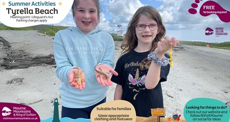 Two girls holding lizards at the beach