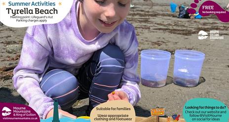 Girl looking closely at something she has found at the beach as part of the Beach Activities