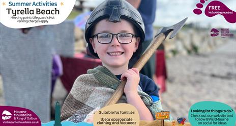 A boy dressed as a viking enjoying beach activities