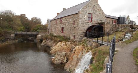 Pictured is Annalong Cornmill which has been beautifully restored. It is situated by the pretty Annalong Harbour at the foothills of the Mourne Mounta