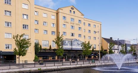 View of the front of the Canal Court Hotel and Spa building, fountain also in the picture.