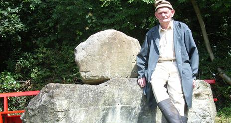 Man leaning on stone