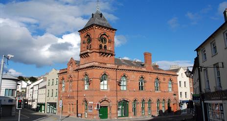 Red brick exterior with town hall clock of Down Arts Centre that sits at the junction of Irish Street, English Street and Scotch Street in Downpatrick