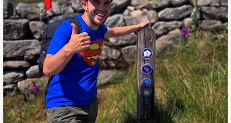 Nathan posing at the way mark sign