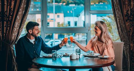 Couple enjoying food and drink at Canal Court Hotel over looking Newry Canal