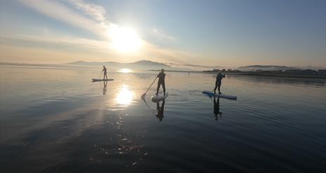 floating into the sunset at Greencastle beach, mourne mountains