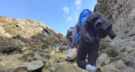 hard at it, reaching the top