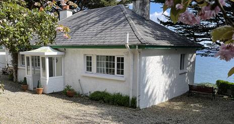 Reception room showing open tread stairs to the attic bedroom, sofa and armchairs.