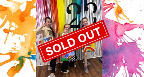 Children holding up tote bags they designed at Studio 23 for Newry Arts Festival.