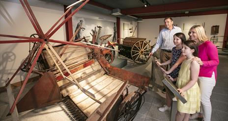 Family looking at objects on display in Down County Museum exhibition