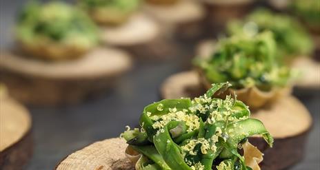 Supper Club at Scopers, Dundrum. Tasting menu of small parcels with green foilage with truffle shavings.