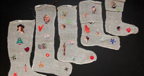 handmade Christmas stockings decorated with magazine cutouts. Part of the DCM collection.