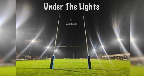 Image showing the goal post at night with the floods turned on. Under the lights by Maria Connolly