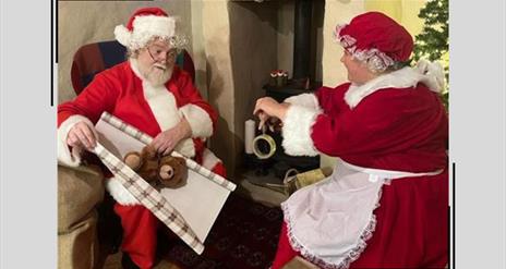Santa and Mrs Claus wrap presents together