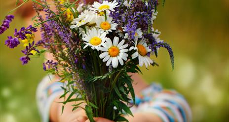 child with bunch of flowers