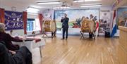Two Lamberg drum and a flautist playing at a Schoberg event in Reivers House Kilkeel