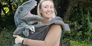 A dino being cuddled in a sling