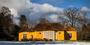 Image credit: Alan Hopps
Derrymore house. A bright yellow cottage with a thatched roof.