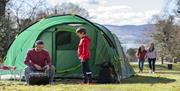 Family enjoying a BBQ infront of their tent in Kilbroney Park