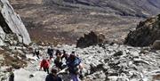 A group of walkers hiking at the Devil's Coachroad, Slieve Beg in the Mourne Mountains