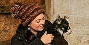 woman holding baby goat