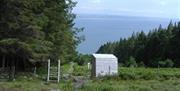 View from mountain to sea with stile and shed