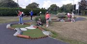 kids playing mini golf in castle park