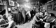 Bar with people drinking at tables