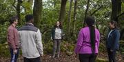 A group of five people in total standing in a circle at a Mindfulness experience, lead by Ann from Xhale.