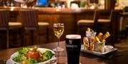 Food on table with wine and Guinness