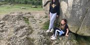 Children leaning against the Cloughmore Stone