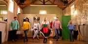 Group in a row with the instructor in front being taught Irish dancing as part of the Dancing at the Crossroads experience