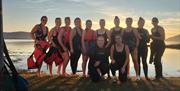 Ladies from a gym group on a team night out enjoying the sunset SUP with Geology Rocks Adventure
