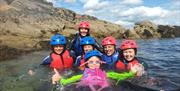 Family enjoying the water (wet bouldering) on a bank holiday