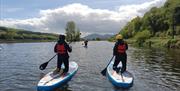 Couple chilling along the Narrow Water journey on their paddle boards