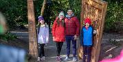 A family getting their picture taken as they walk through the wardrobe at the start of the Narnia Trail in Kilbroney Park, Rostrevor.