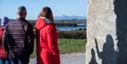 Family enjoying the view of the Mourne Mountains from Strangford Stone in Delamont Country Park.