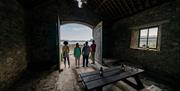 Group standing in a building enjoying the scenery with A Taste of Castle Ward in Strangford