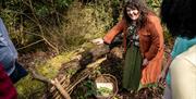 Guide showing a basket of items she has foraged with A Taste of Castle Ward