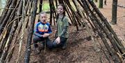 Children in bush craft structure