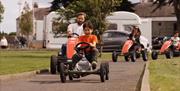 Family on go karts in castle park