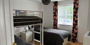 second bedroom with bunkbeds and trundle bed