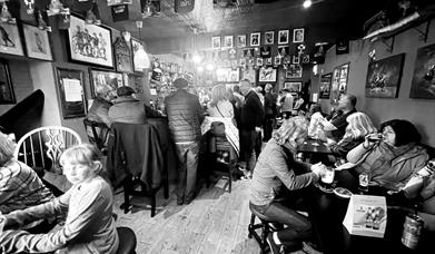 Bar with people drinking at tables