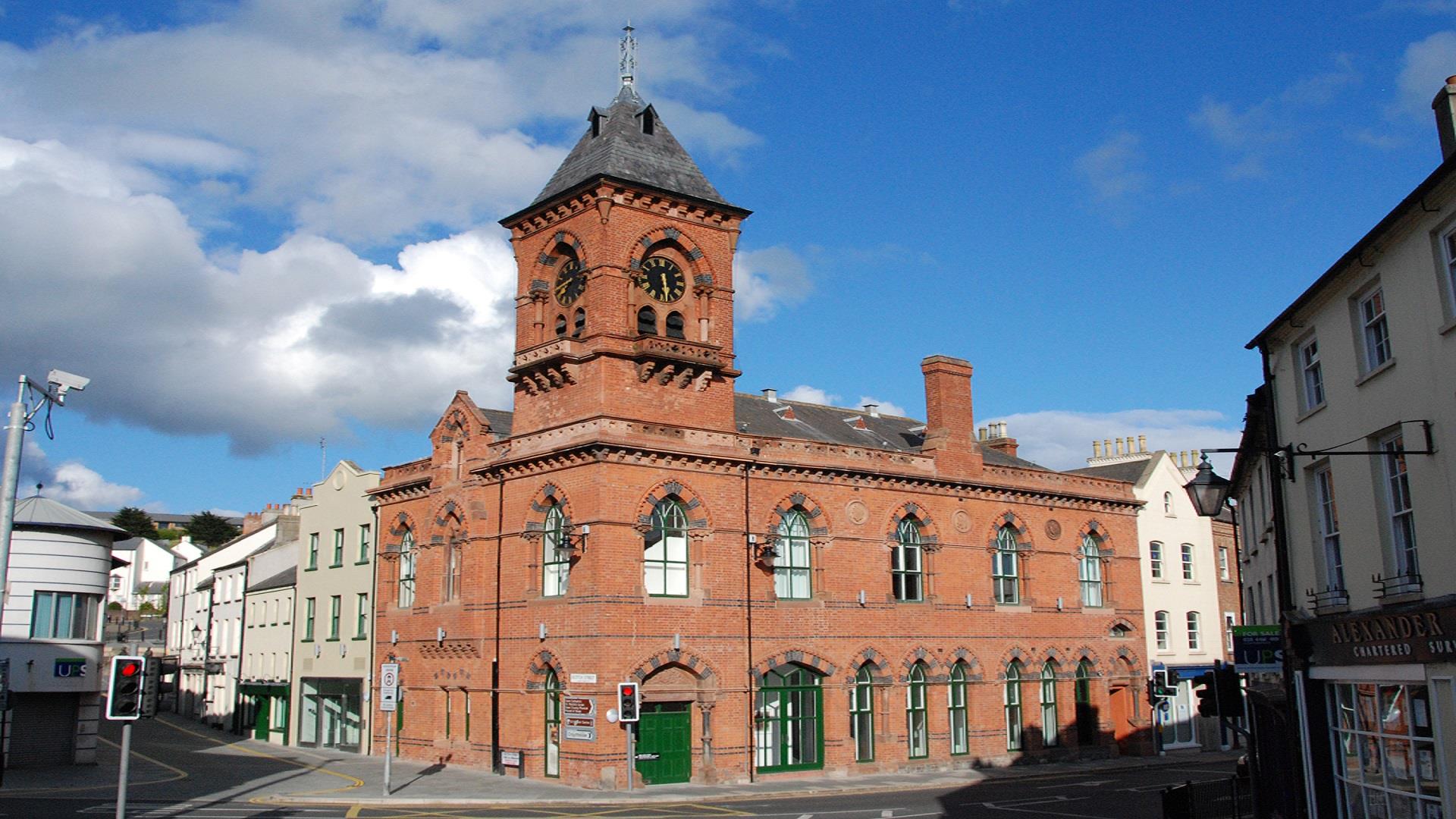 Red brick exterior with town hall clock of Down Arts Centre that sits at the junction of Irish Street, English Street and Scotch Street.
